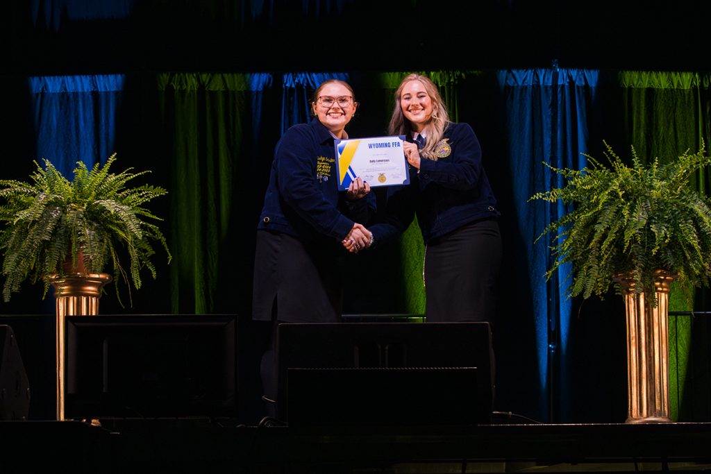 A Wyoming FFA member receives their state degree on stage